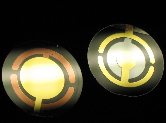 Two QCMs with
            inlaid, circular golden electrodes. 